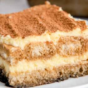 slice of tiramisu with layers of mascarpone filling and ladyfingers