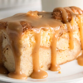 bread pudding slice with bourbon sauce dripping down