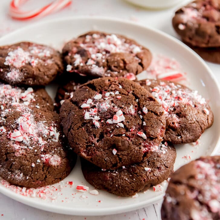 chocolate peppermint cookies on a plate with crushed candy cane pieces