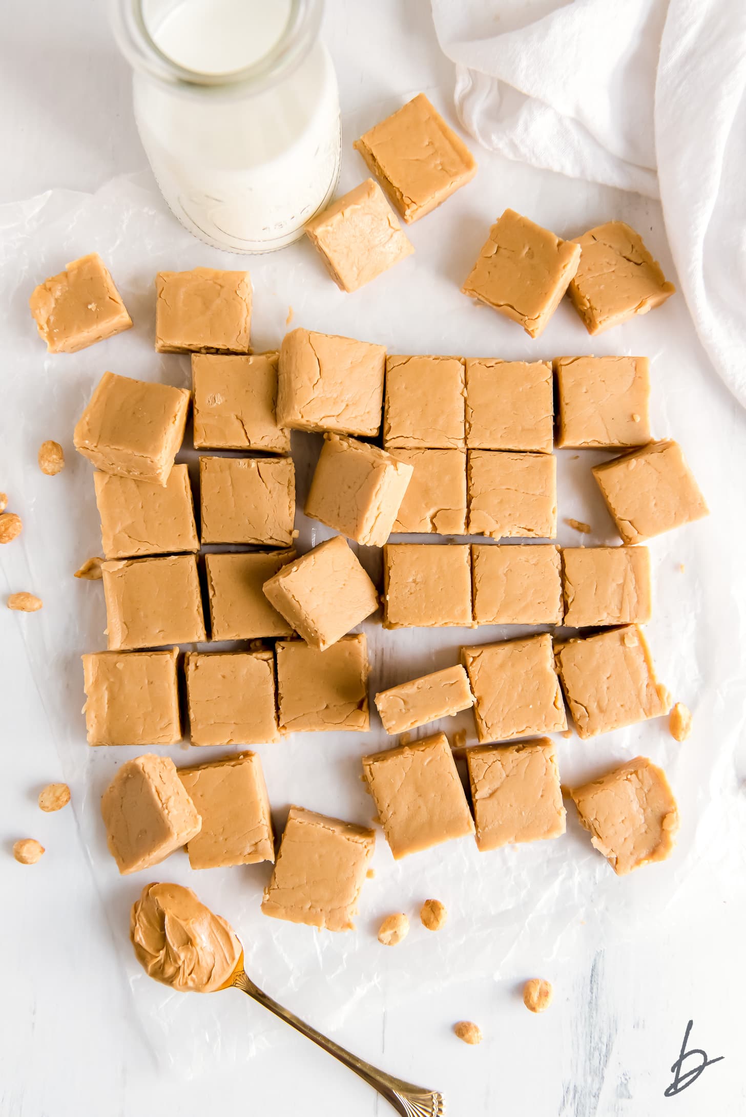peanut butter fudge cut into squares on wax paper