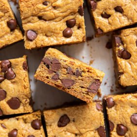 chocolate chip cookie bars cut in square with one bar on its side