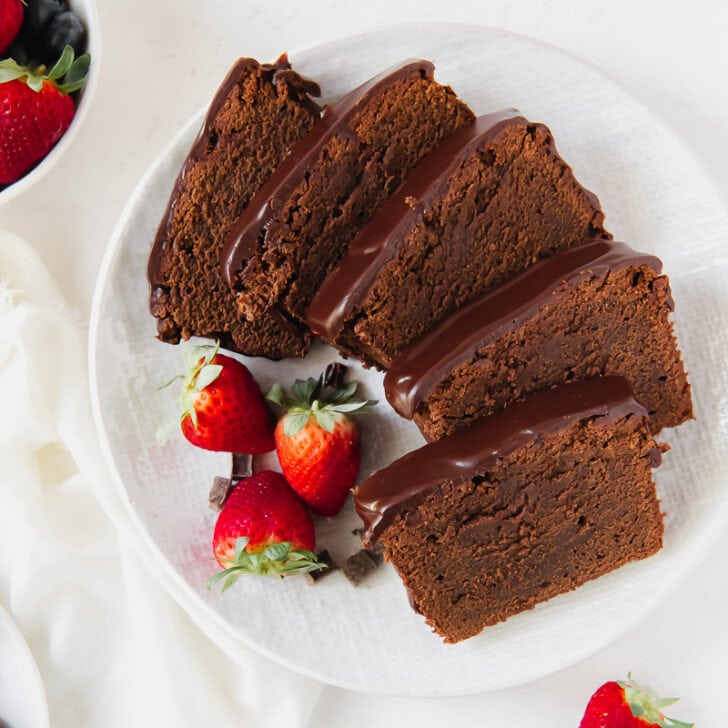 chocolate pound cake slices on a plate with strawberries