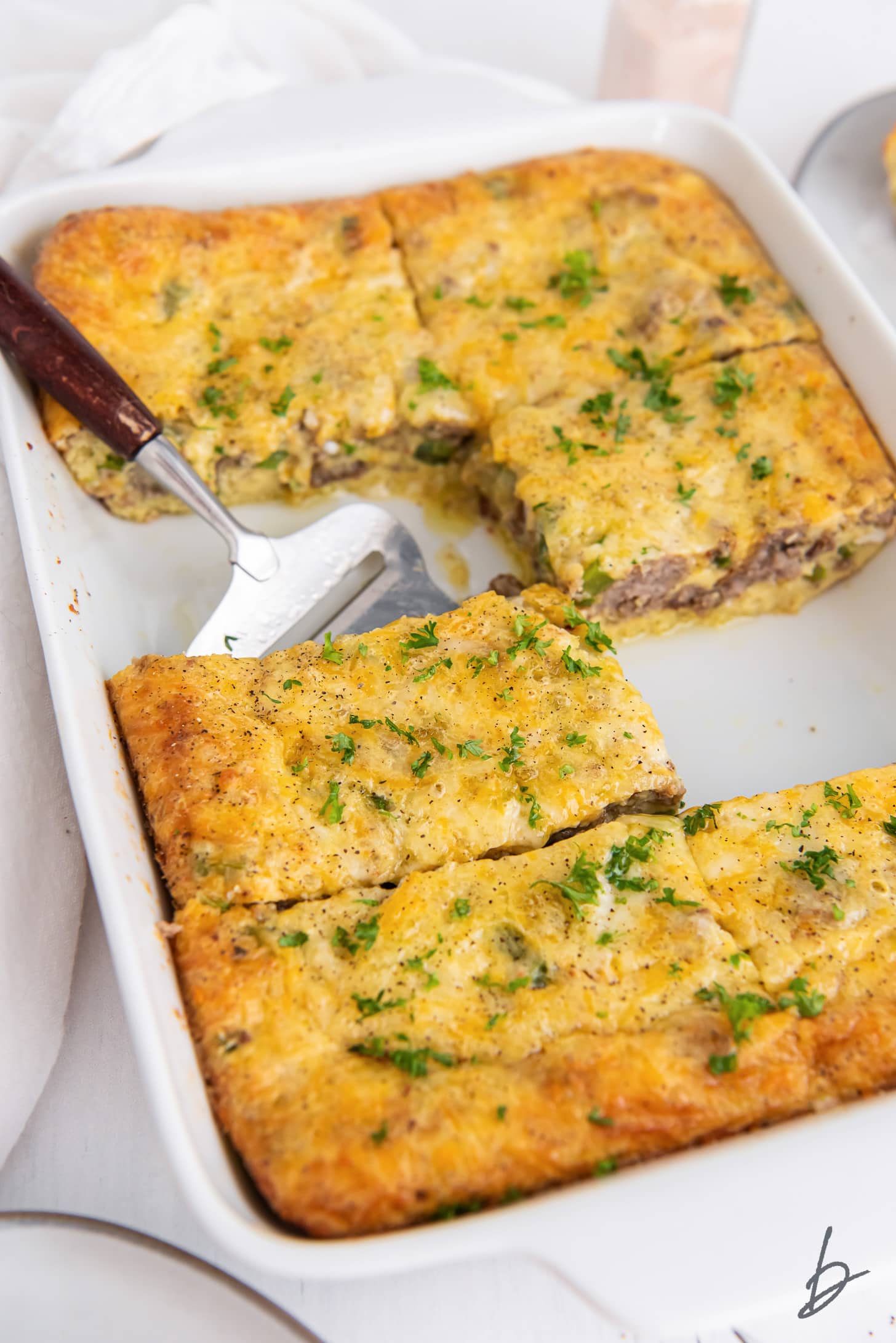 sausage breakfast casserole sliced into rectangles in a baking dish