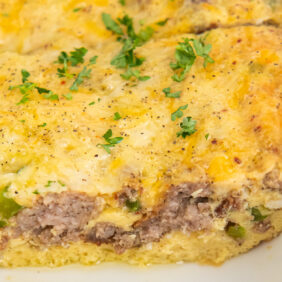 side of slice of sausage breakfast casserole in a dish