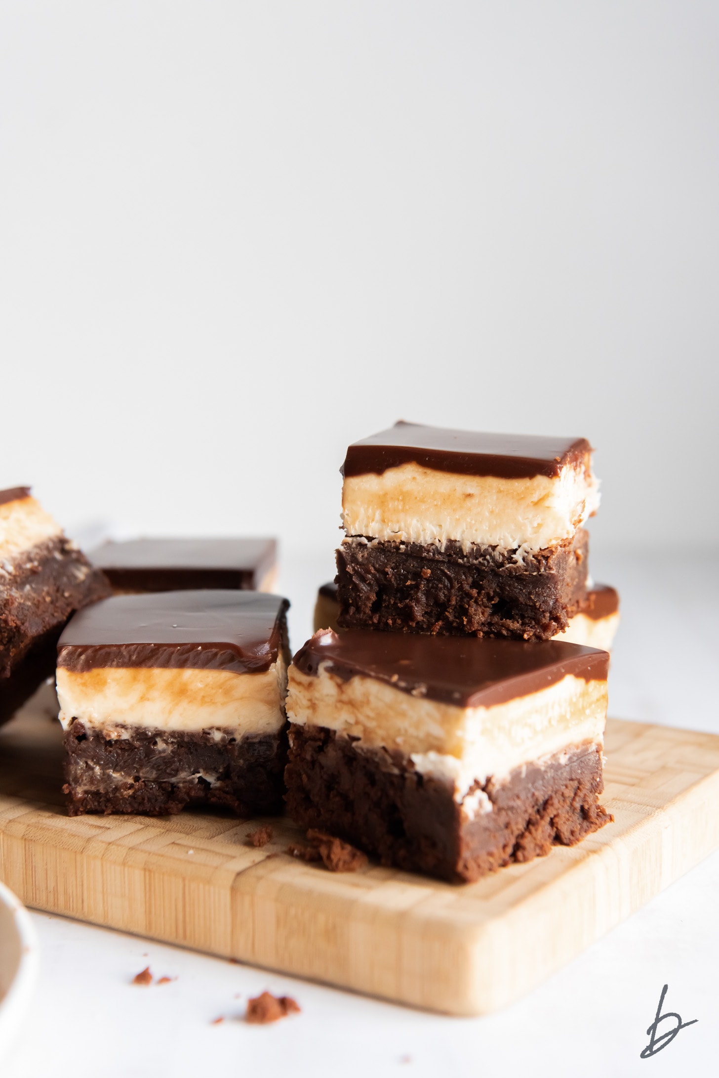 two bailey's brownies stacked on top of each other on wood board.