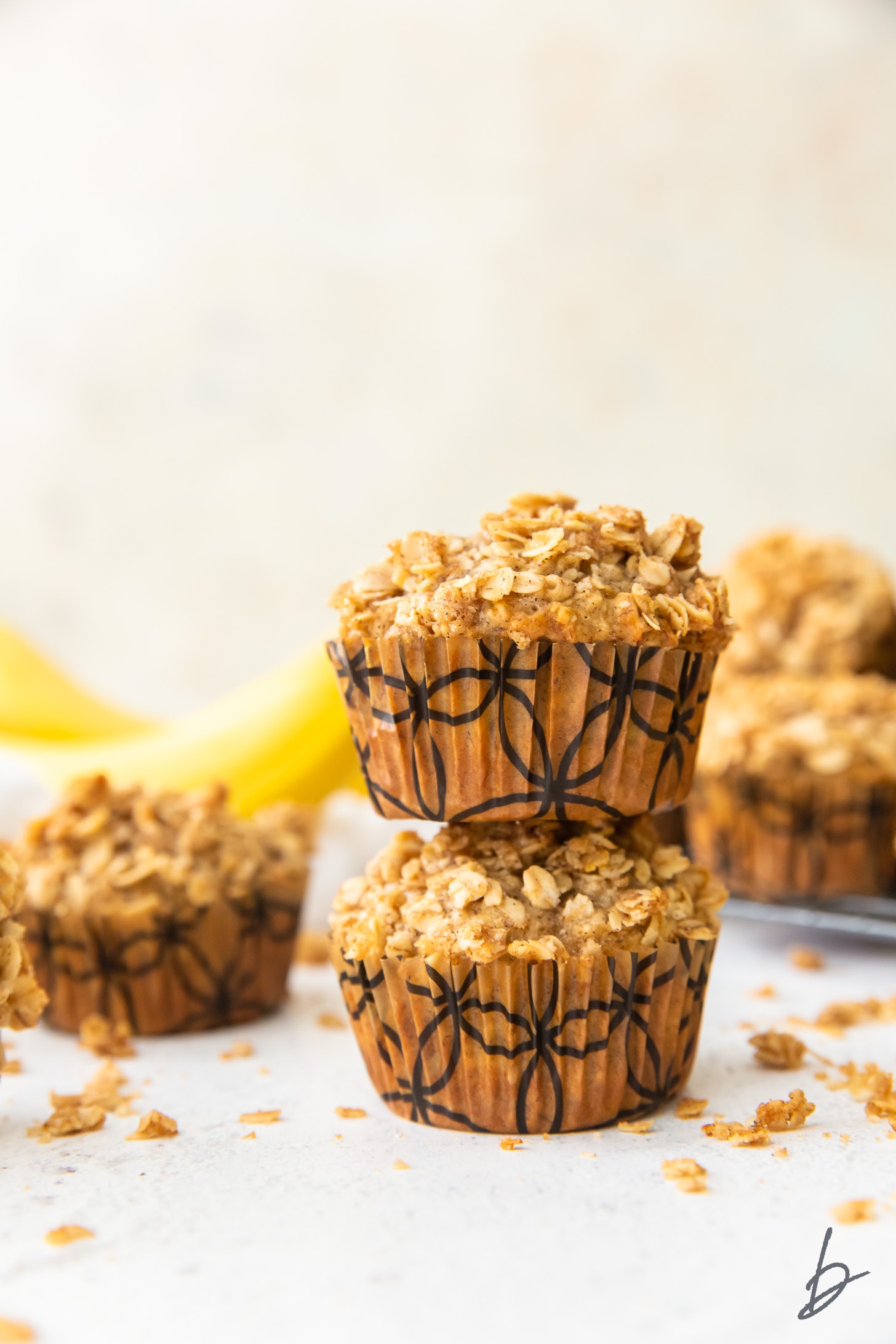 stack of two banana oatmeal muffins with streusel