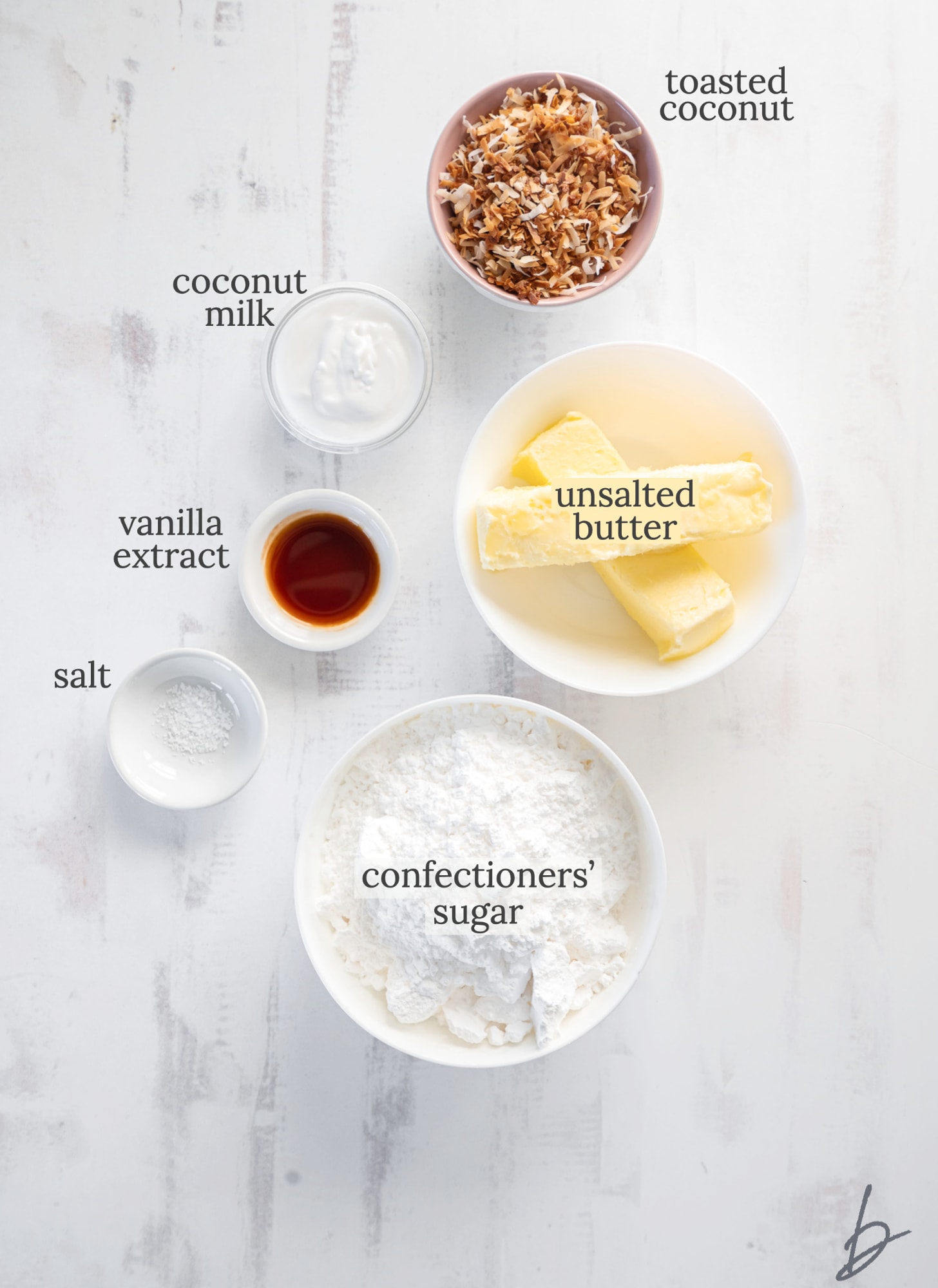 coconut buttercream frosting ingredients in bowls labeled with text