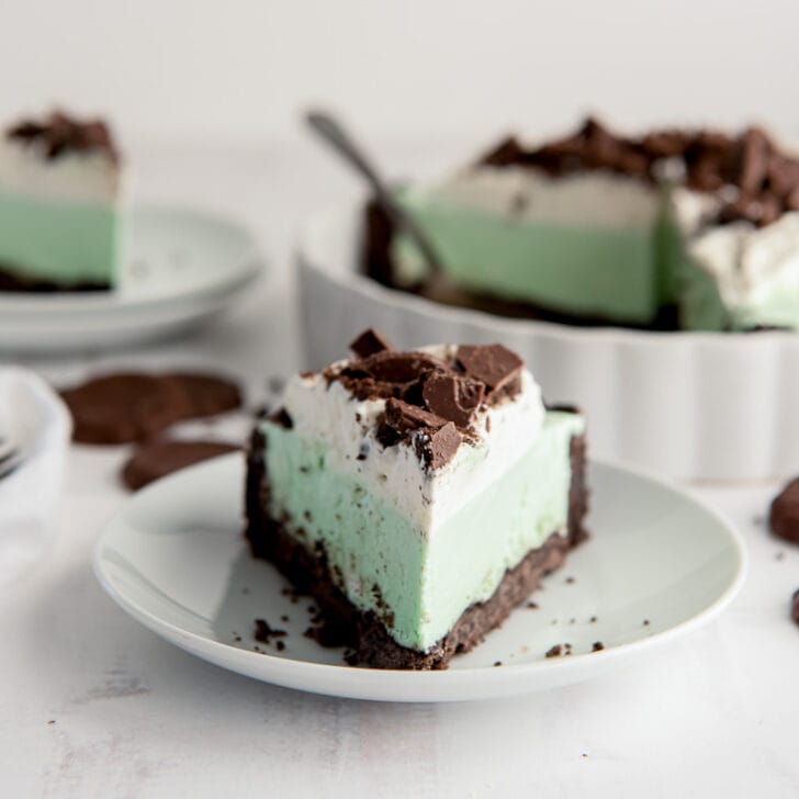 slice of grasshopper pie with chocolate cookie crust on white round plate
