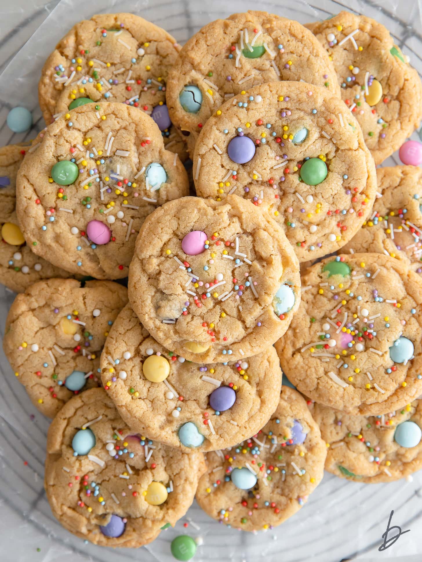 easter cookies with pastel m&ms and sprinkles in a pile