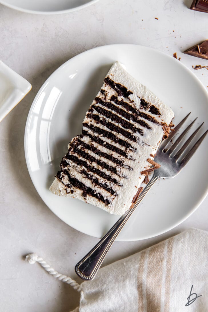 slice of chocolate icebox cake with chocolate wafer layers on a plate with a fork