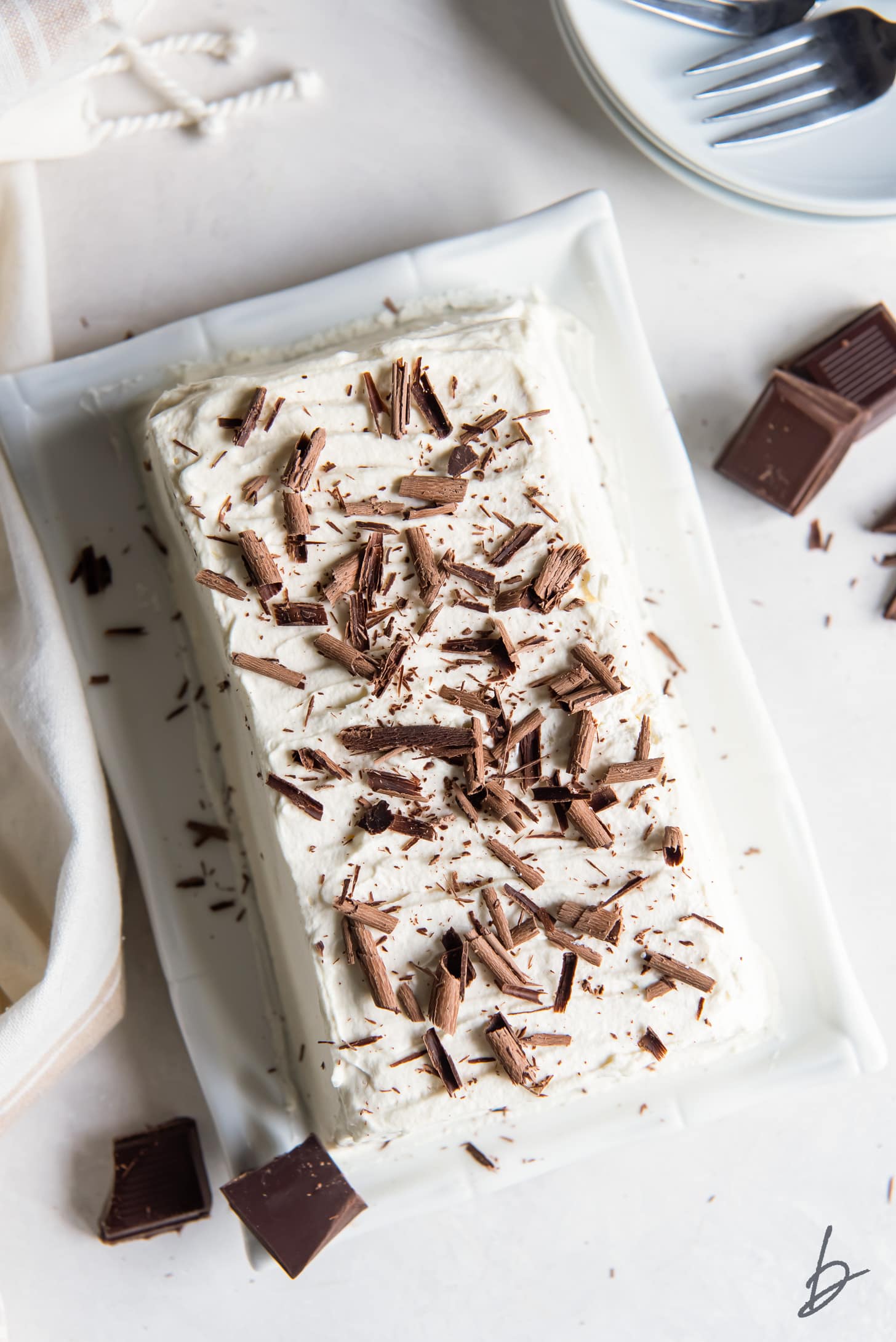 chocolate shavings on top of icebox cake covered in whipped cream