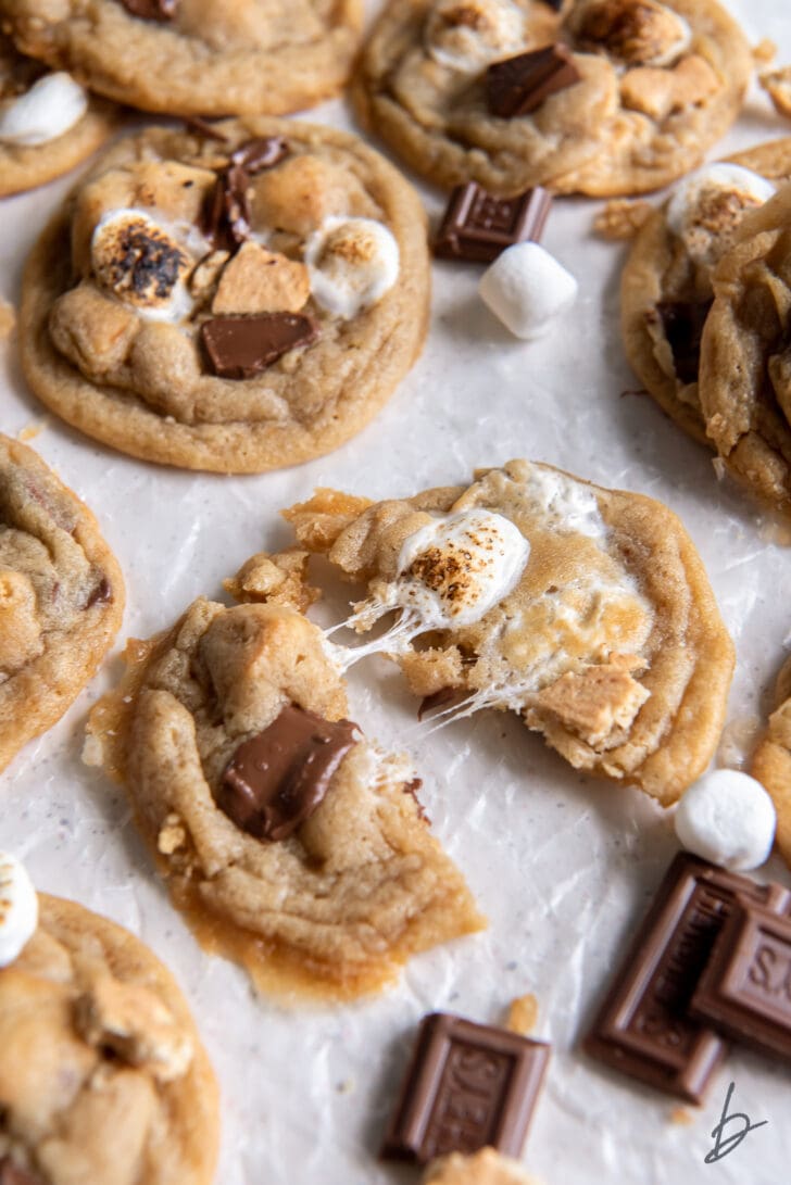 smores cookie pulled apart showing gooey marshmallow and melted chocolate