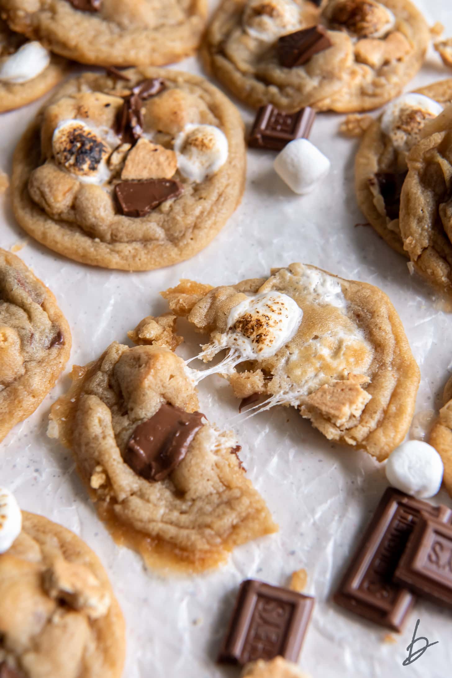 smores cookie pulled apart showing gooey marshmallow and melted chocolate