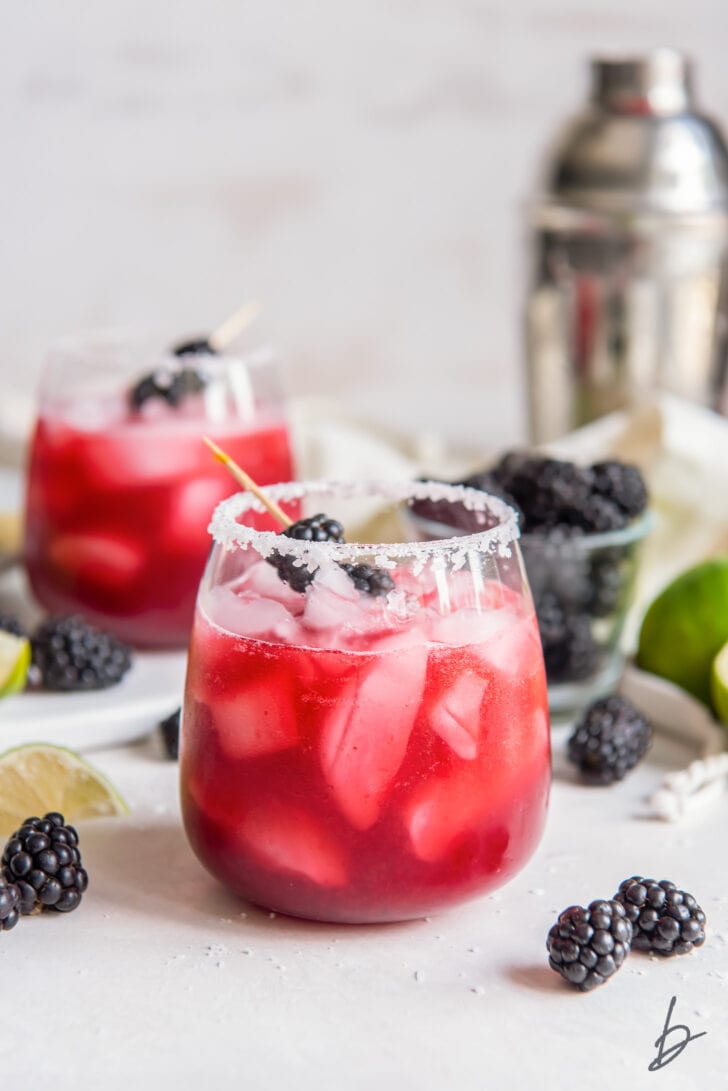 blackberry margarita in a glass with salted rim
