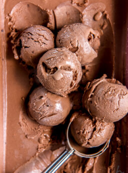 scoops of no churn chocolate ice cream on unscooped ice cream