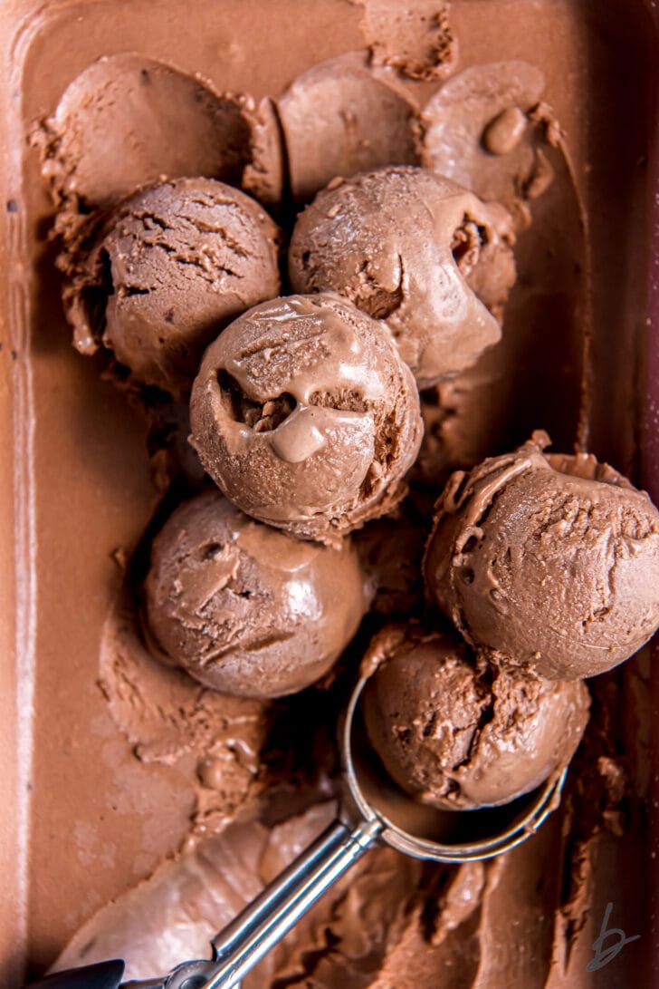 scoops of no churn chocolate ice cream on unscooped ice cream