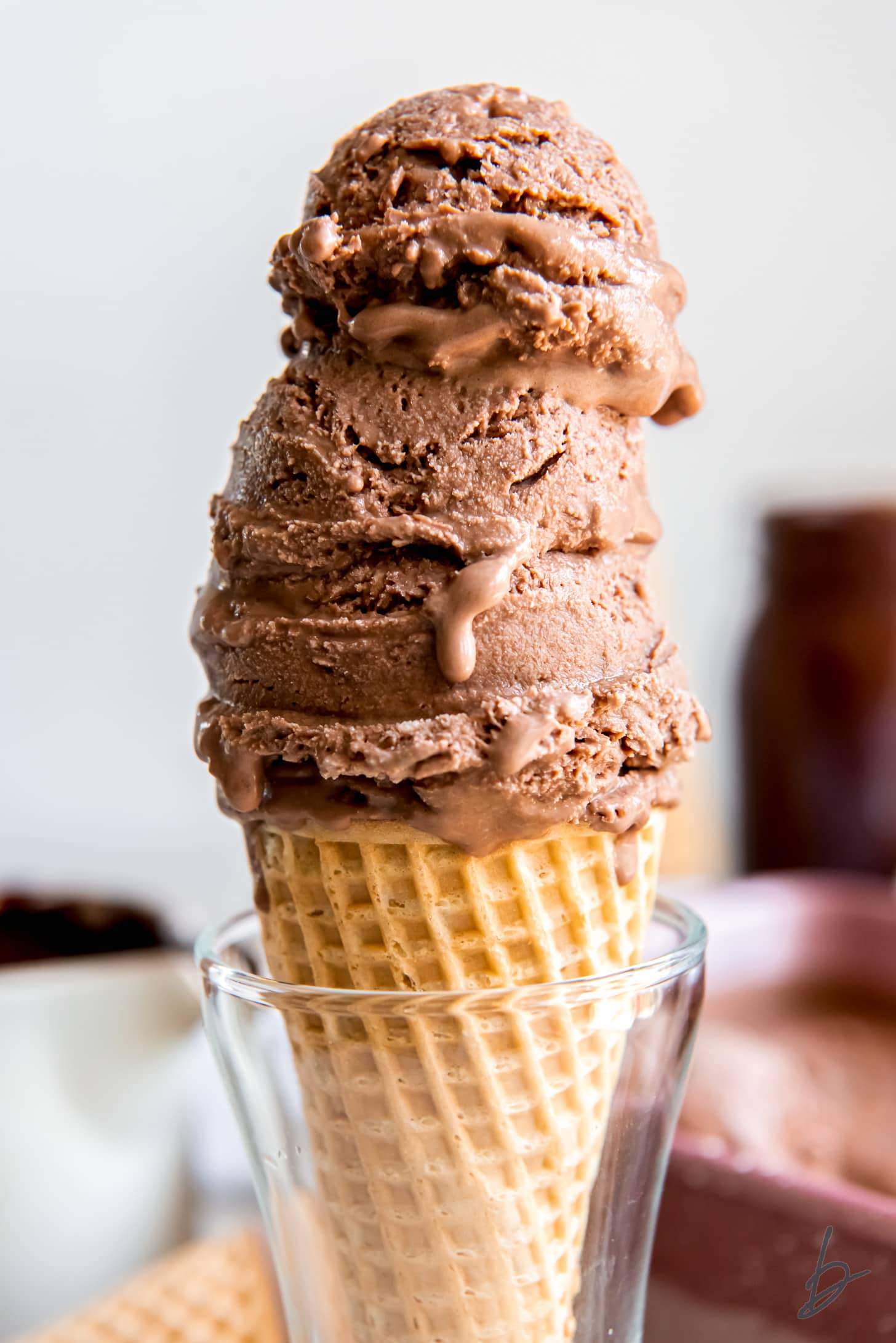 three scoops of chocolate ice cream in a sugar cone