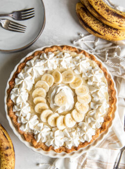 banana cream pie garnished with whipped cream and banana slices