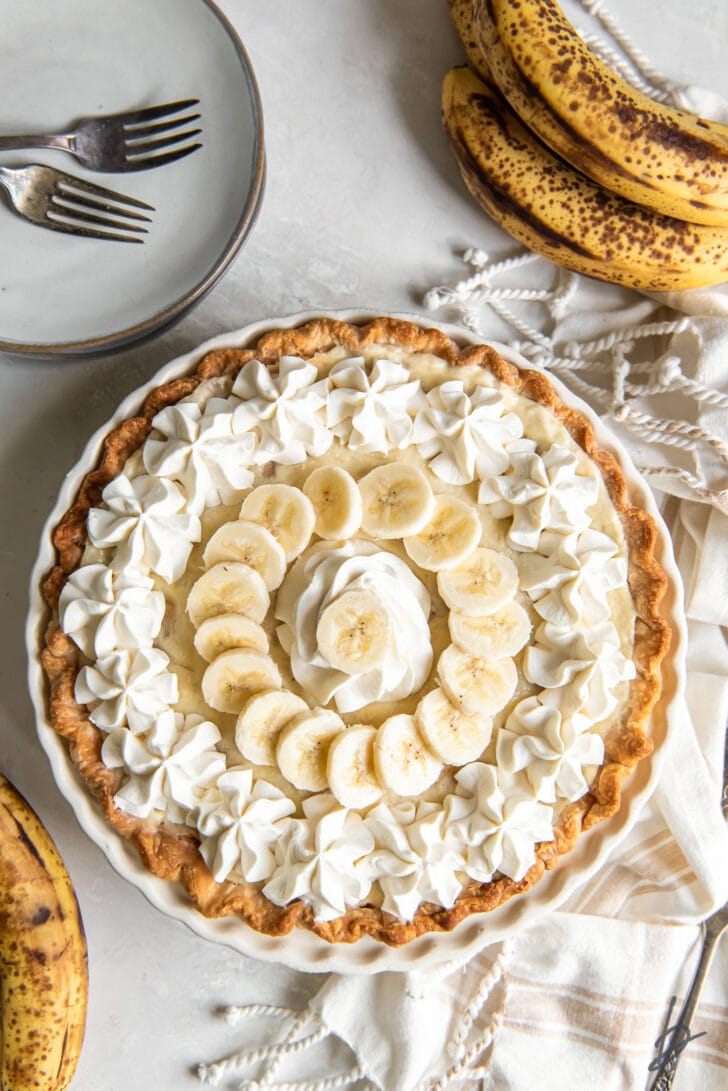 banana cream pie garnished with whipped cream and banana slices