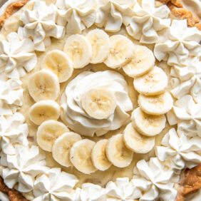 whipped cream and banana slices topping banana cream pie