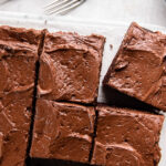 tops of square slices of chocolate zucchini cake with chocolate frosting