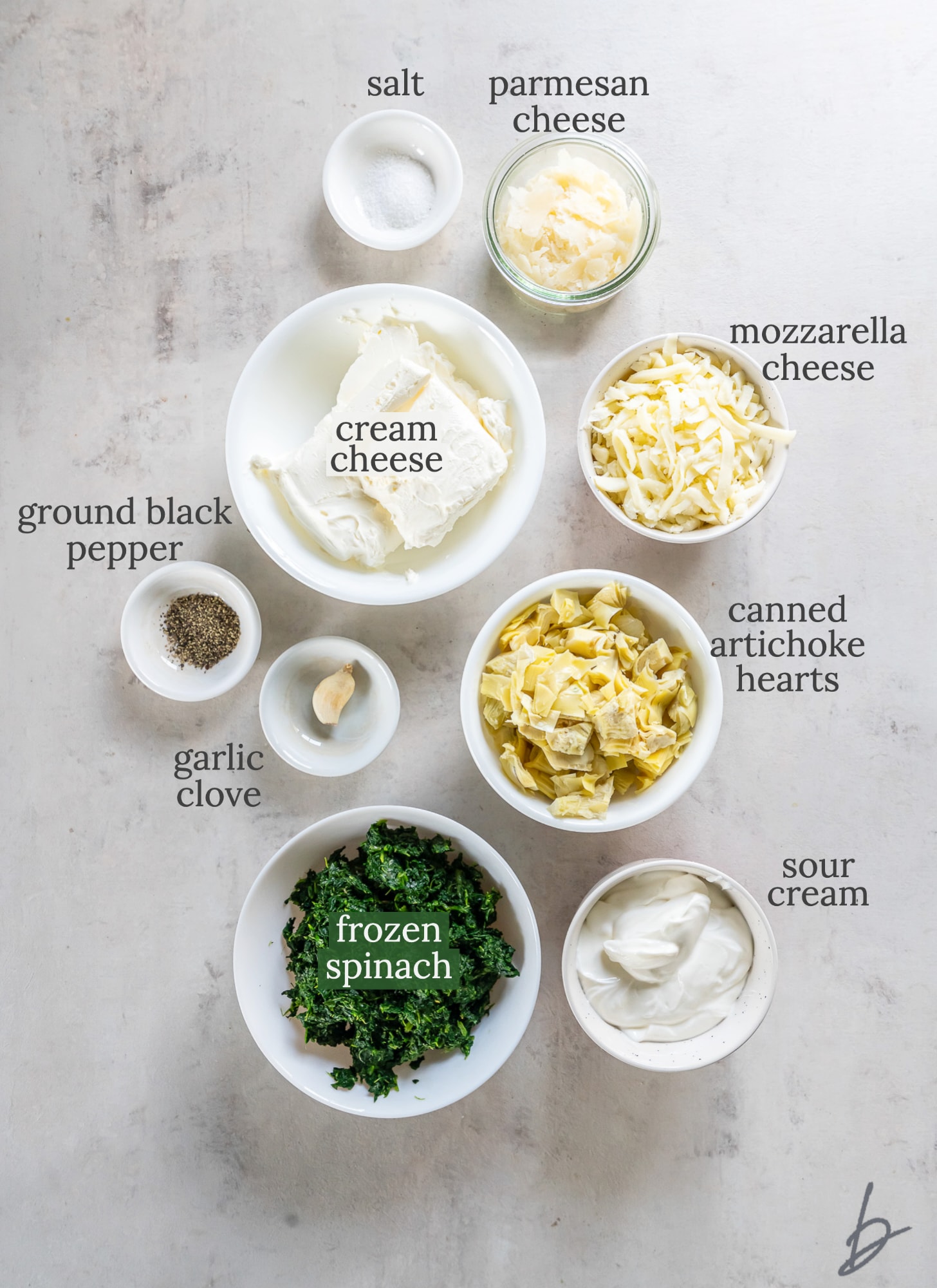 crockpot spinach artichoke dip ingredients in bowls labeled with text