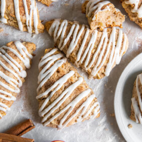 apple cinnamon scones with glaze drizzled on top