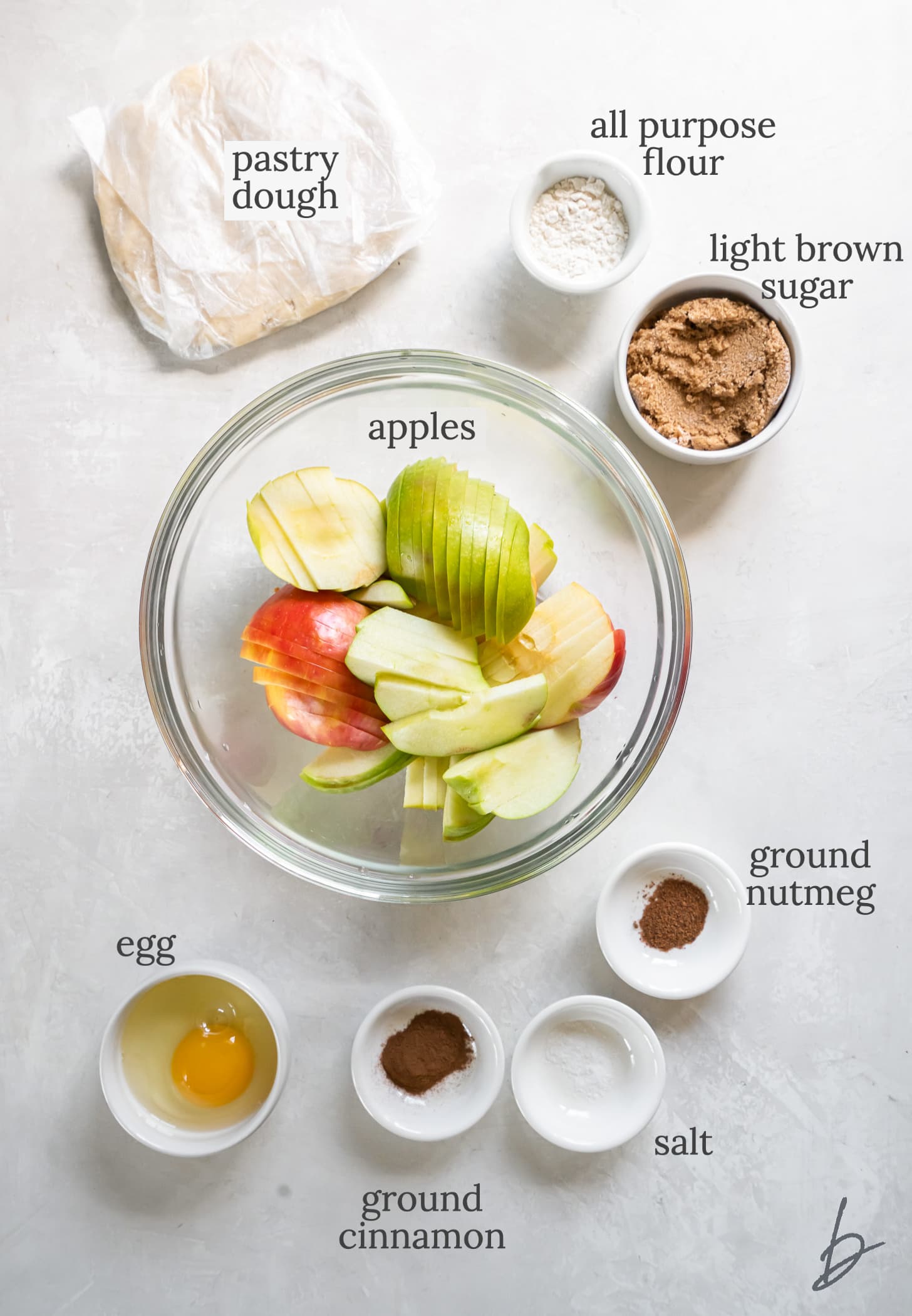 apple galette ingredients in bowls labeled with text.