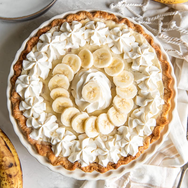 banana cream pie with whipped cream and banana slices on top.
