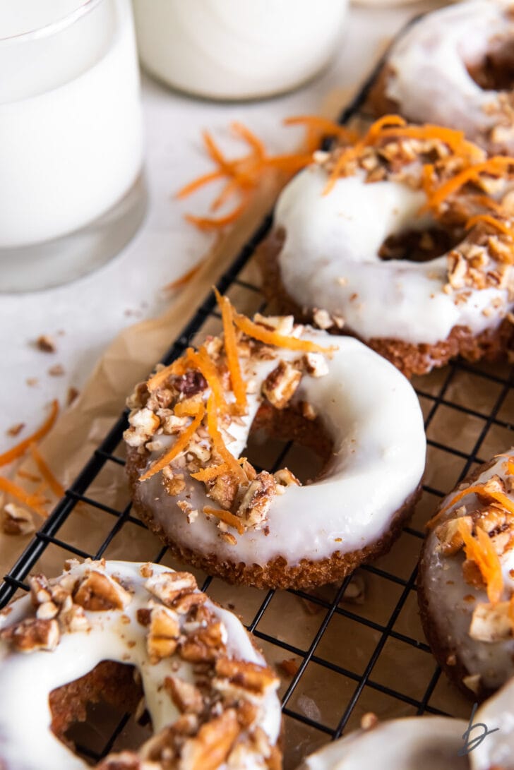 frosted carrot cake donuts garnish with chopped nuts and shredded carrot