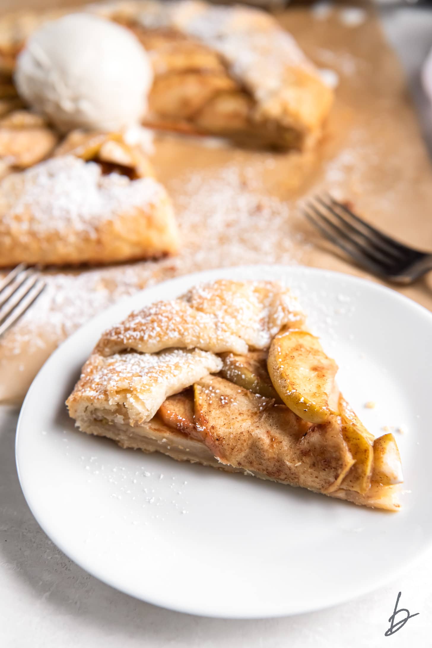 slice of apple galette on a white round plate.