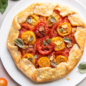 fresh tomato galette on a large white round plate
