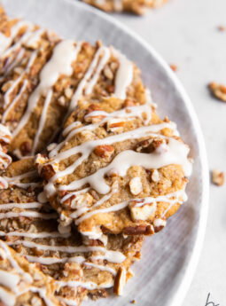 maple brown sugar cookie with chopped pecans and maple drizzle on plate.