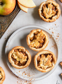 plate of three mini apple pies with top crust leaf cutouts.