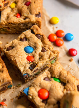 monster cookie bar with m&ms on parchment paper.