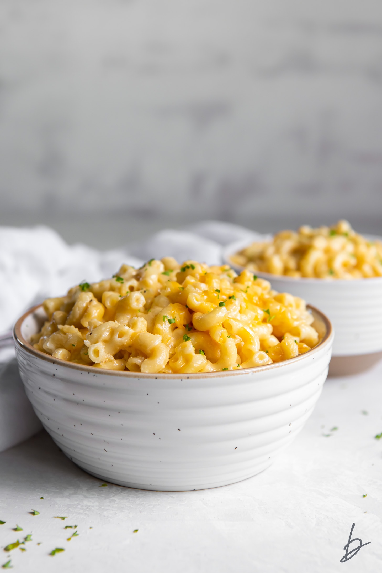 small white bowl filled with mac and cheese.