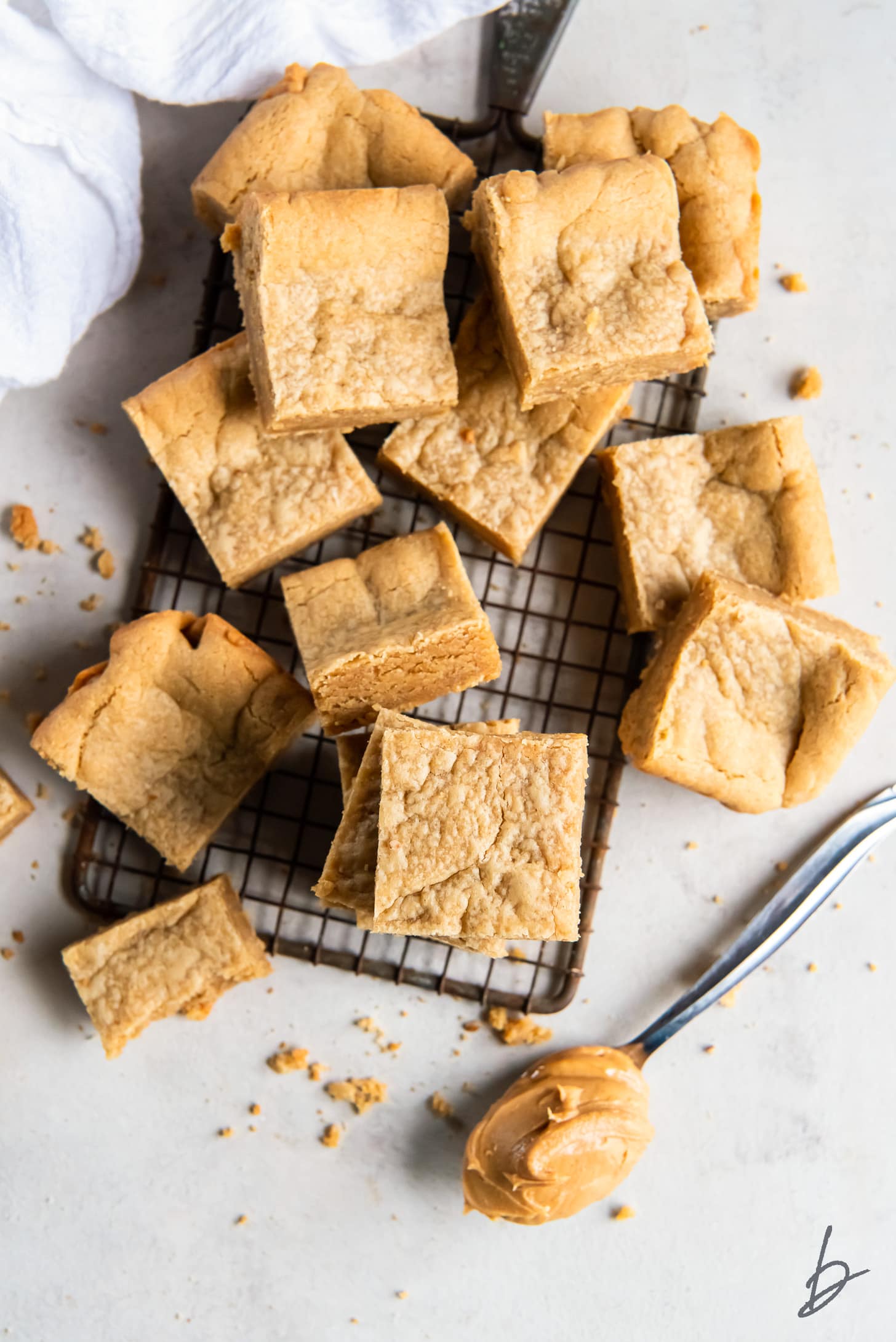 peanut butter cookie bars piled on small wire cooling rack.