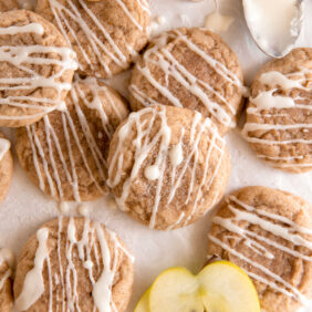 soft apple cider cookies with icing drizzled on top.