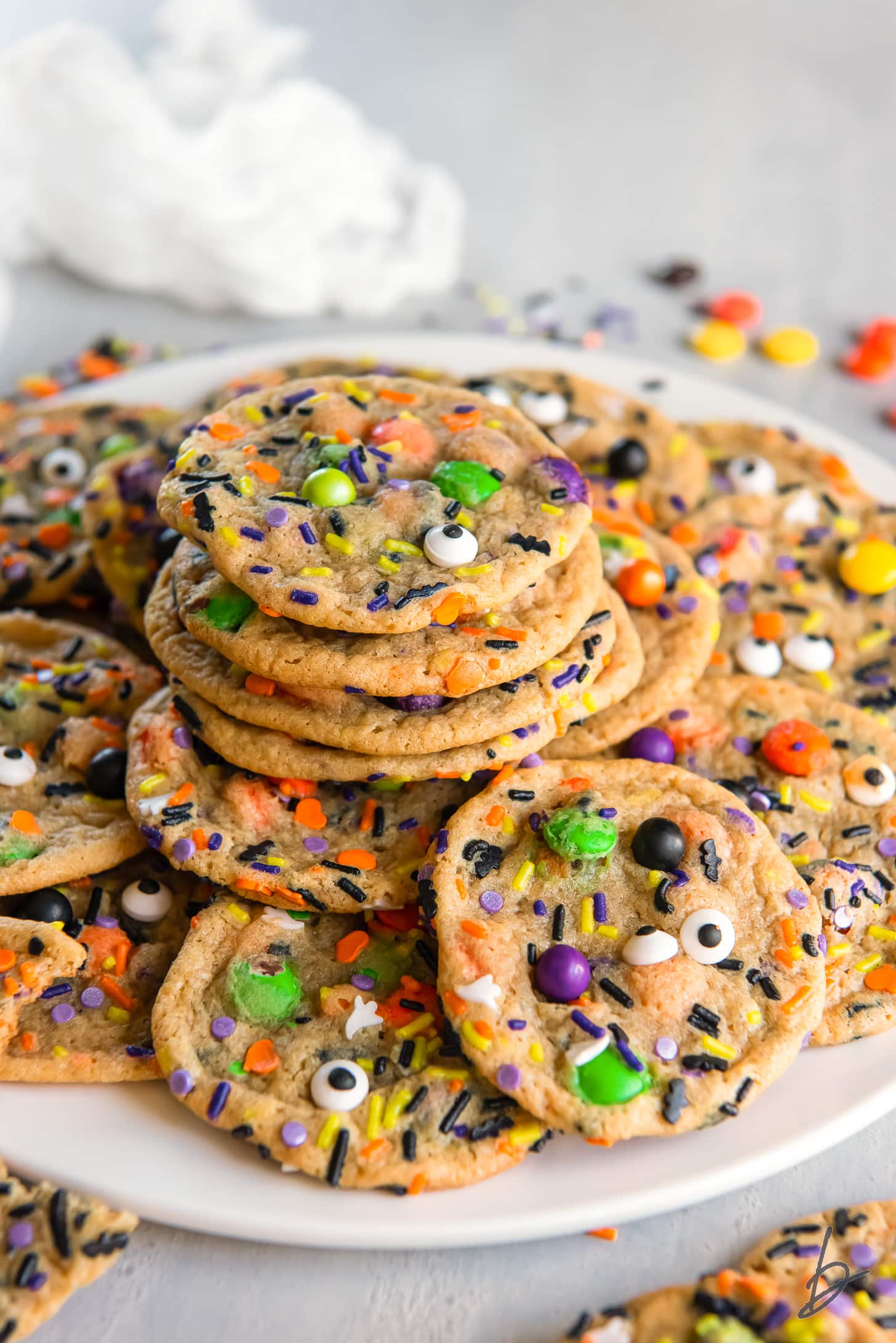 easy halloween cookies in a pile on a white plate.
