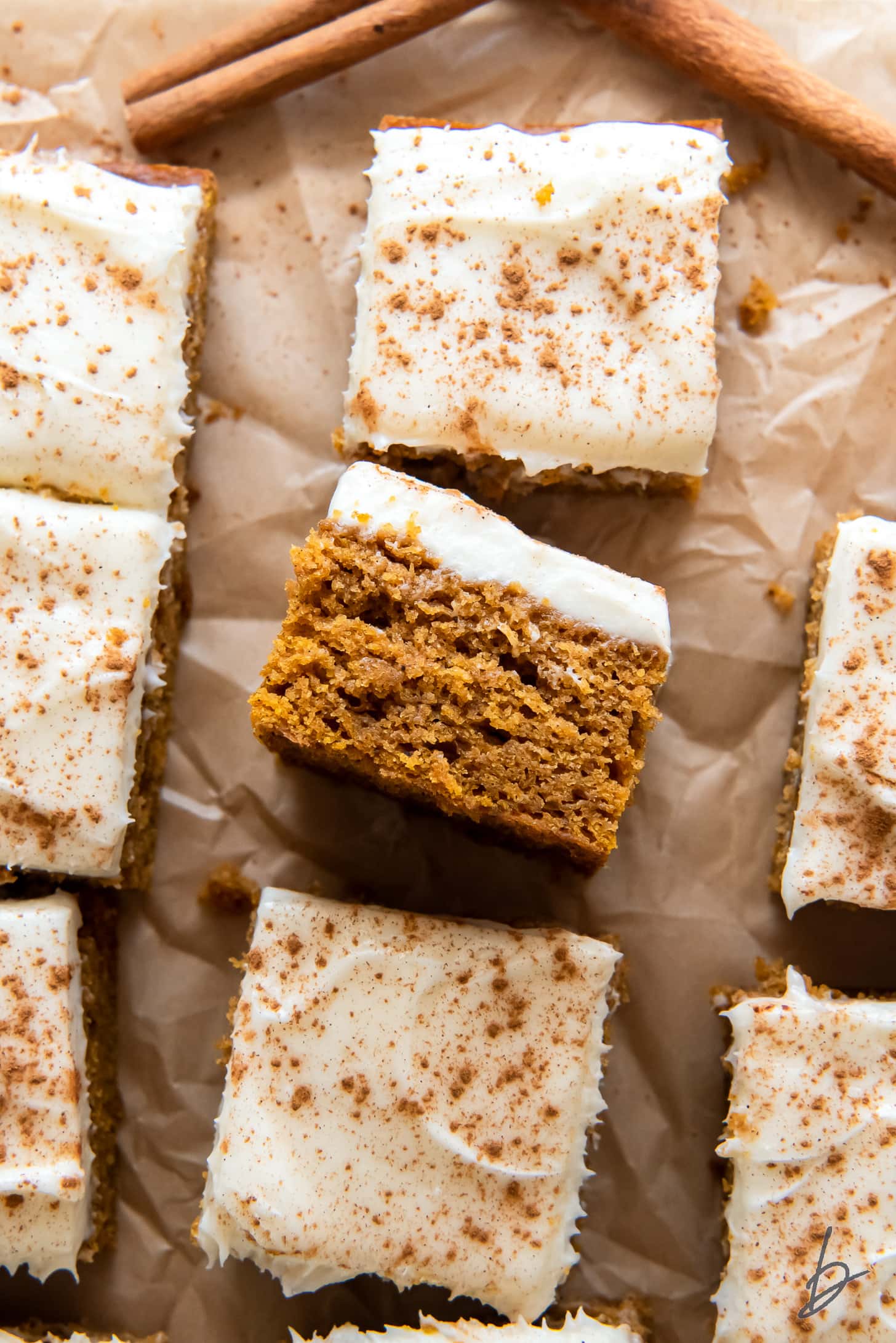 pumpkin bar on its side next to make bars with cream cheese frosting.