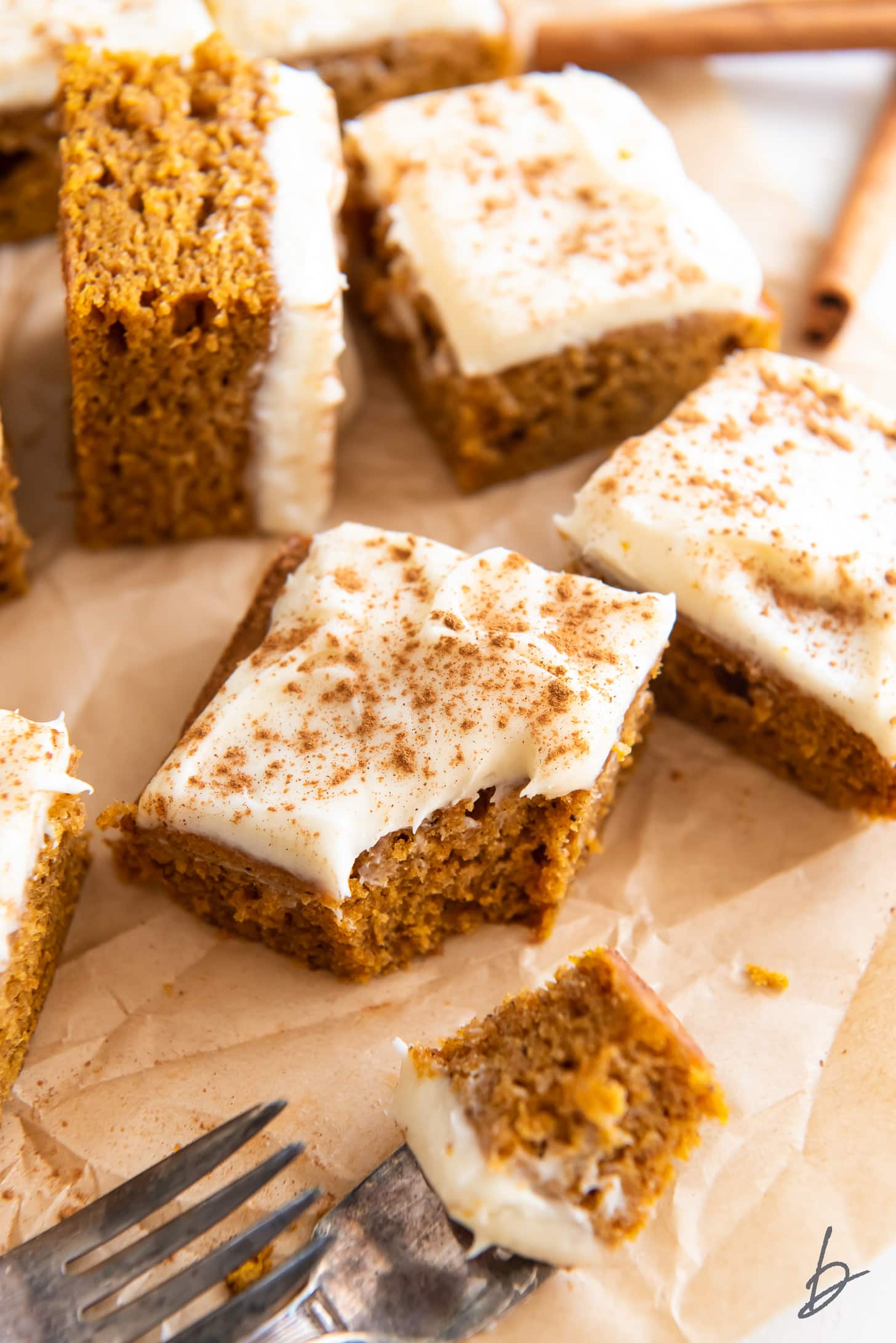 pumpkin bar with cream cheese frosting and bite taken off the corner.