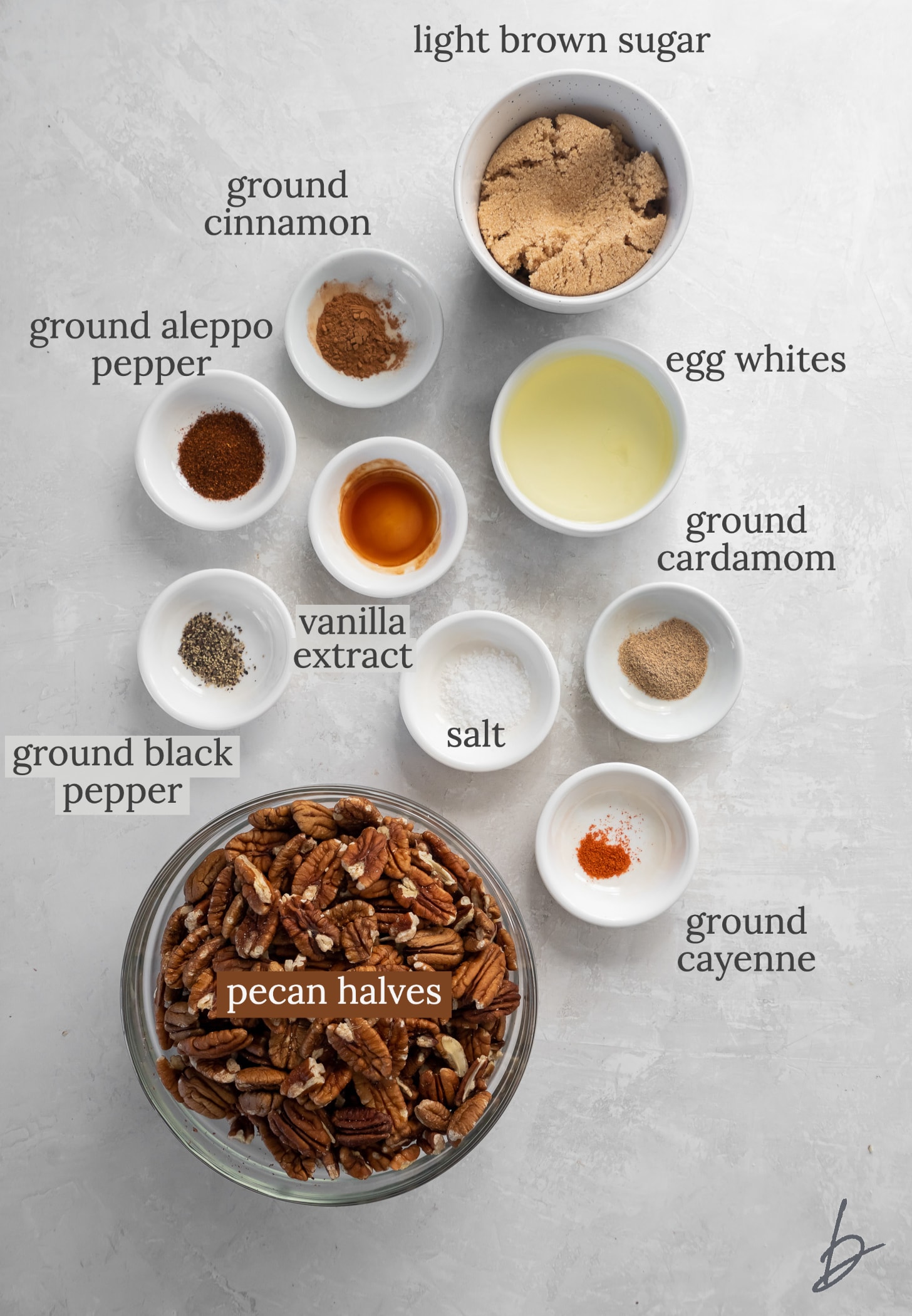 spiced pecans ingredients in bowls labeled with text.