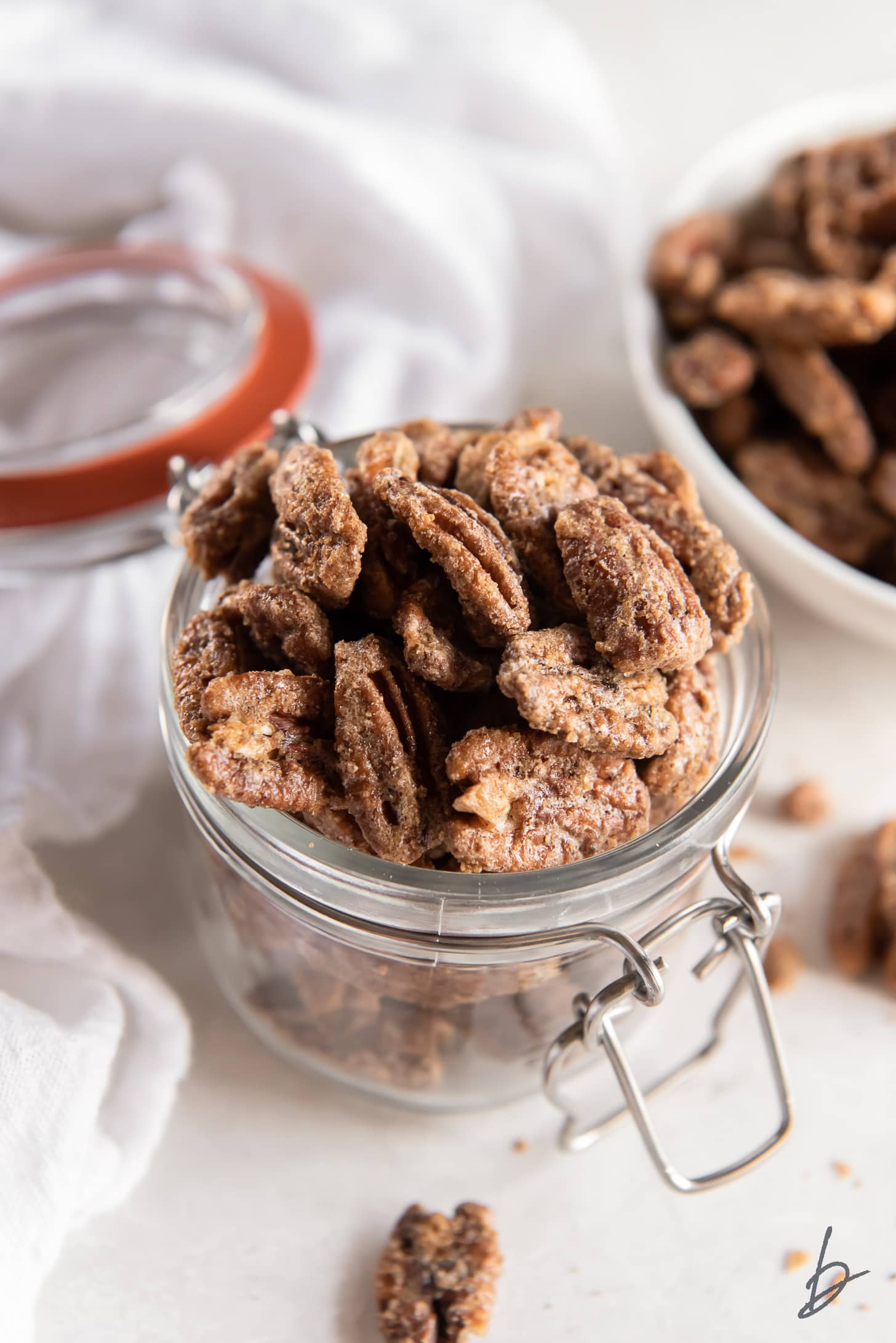 spiced pecans in a glass jar.