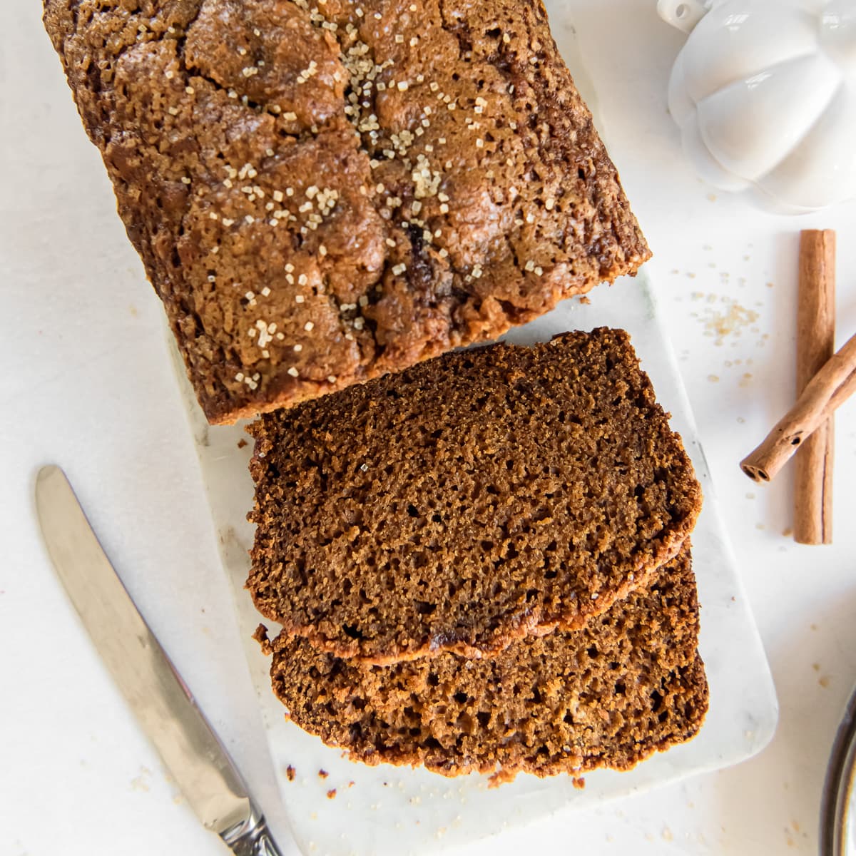 pumpkin gingerbread loaf with two slices cut off the end.