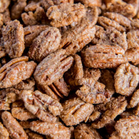 pile of spiced pecans with spicy sugar coating.