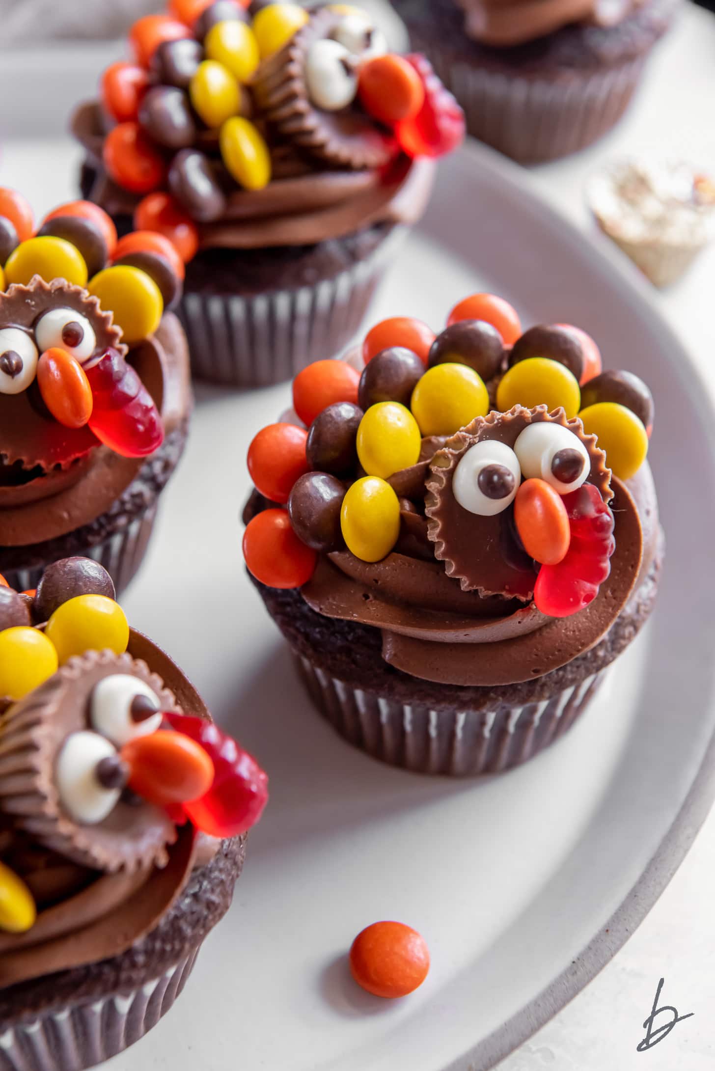 chocolate turkey cupcakes with reese's on a plate.