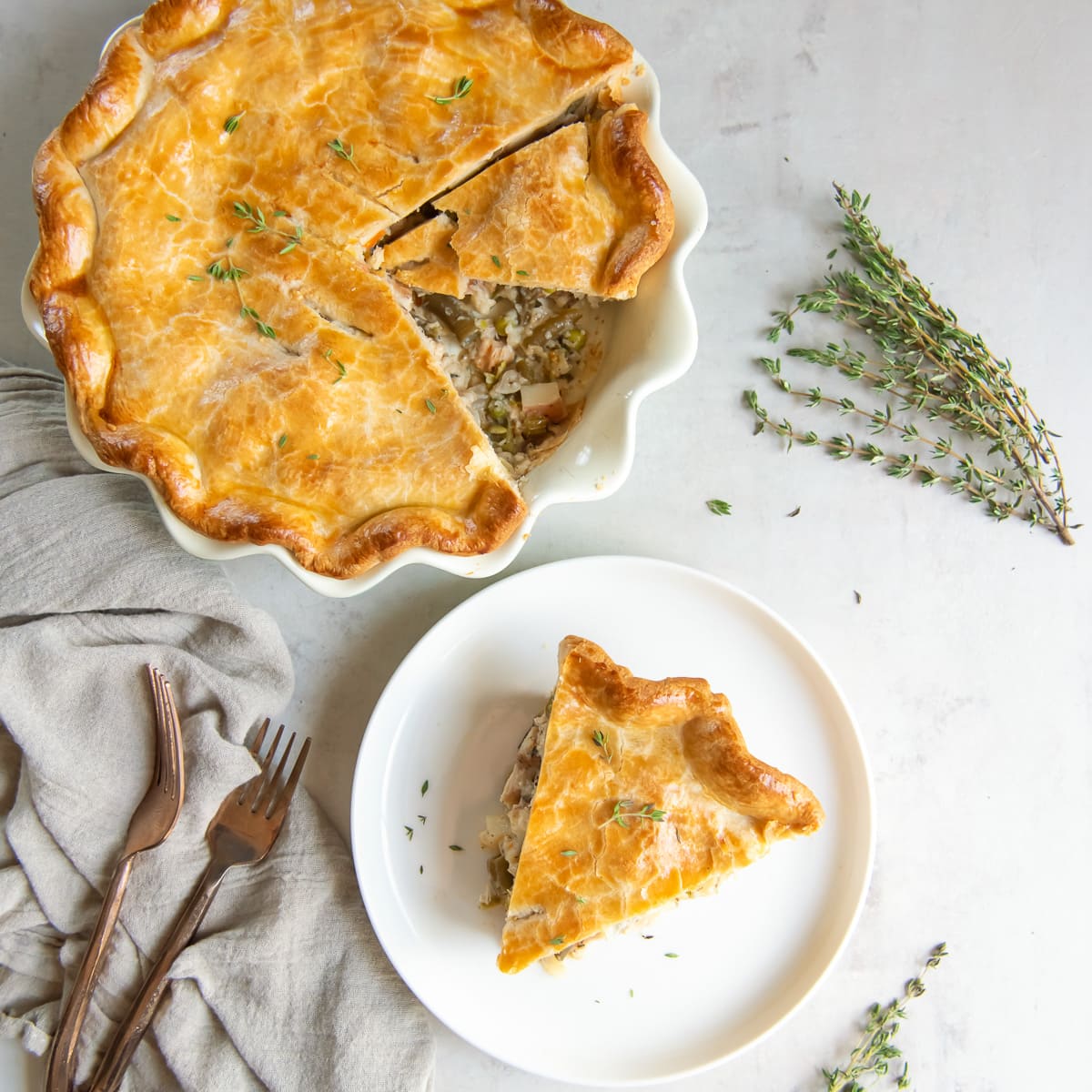 slice of turkey pot pie next to pie in pie dish.