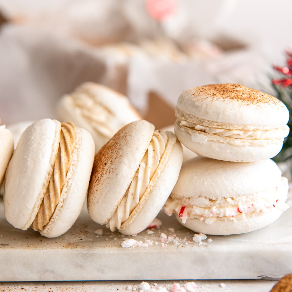 christmas macarons leaning against each other.