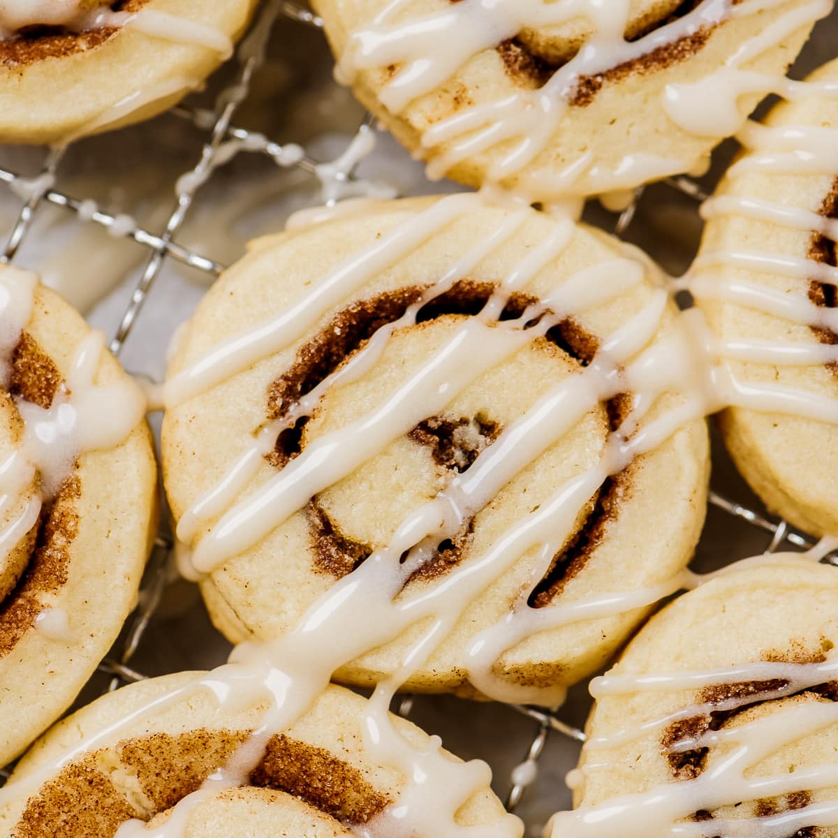 cinnamon roll cookie with drizzle of glaze on top.