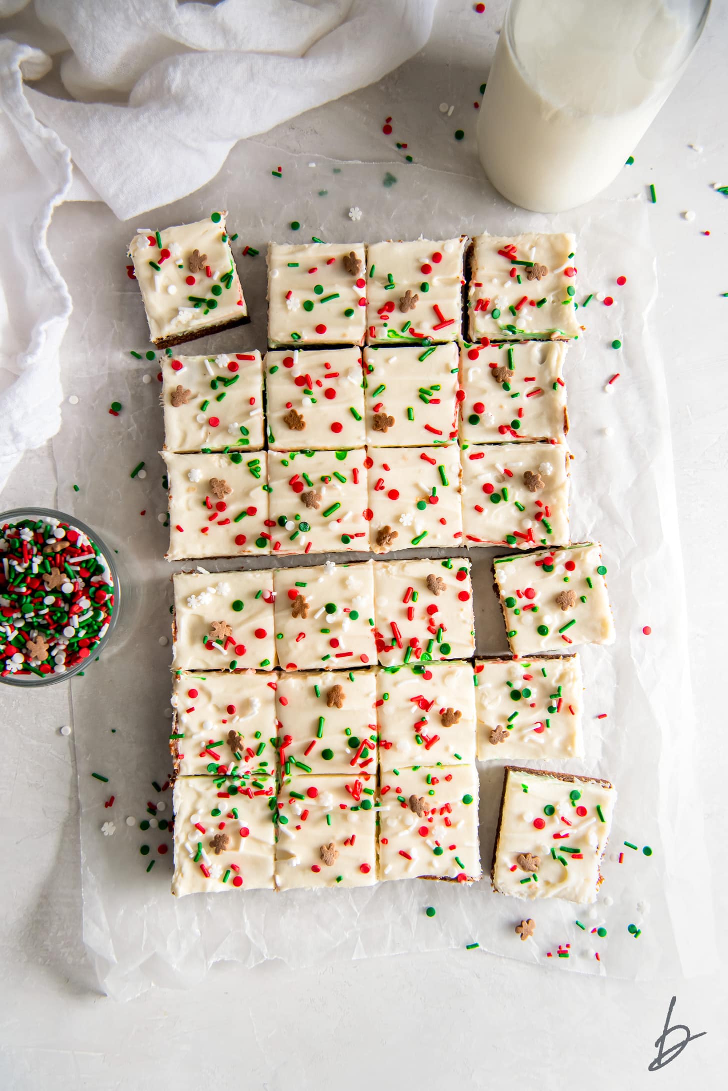 tops of gingerbread cookie bars with cream cheese frosting and sprinkles cut into squares.